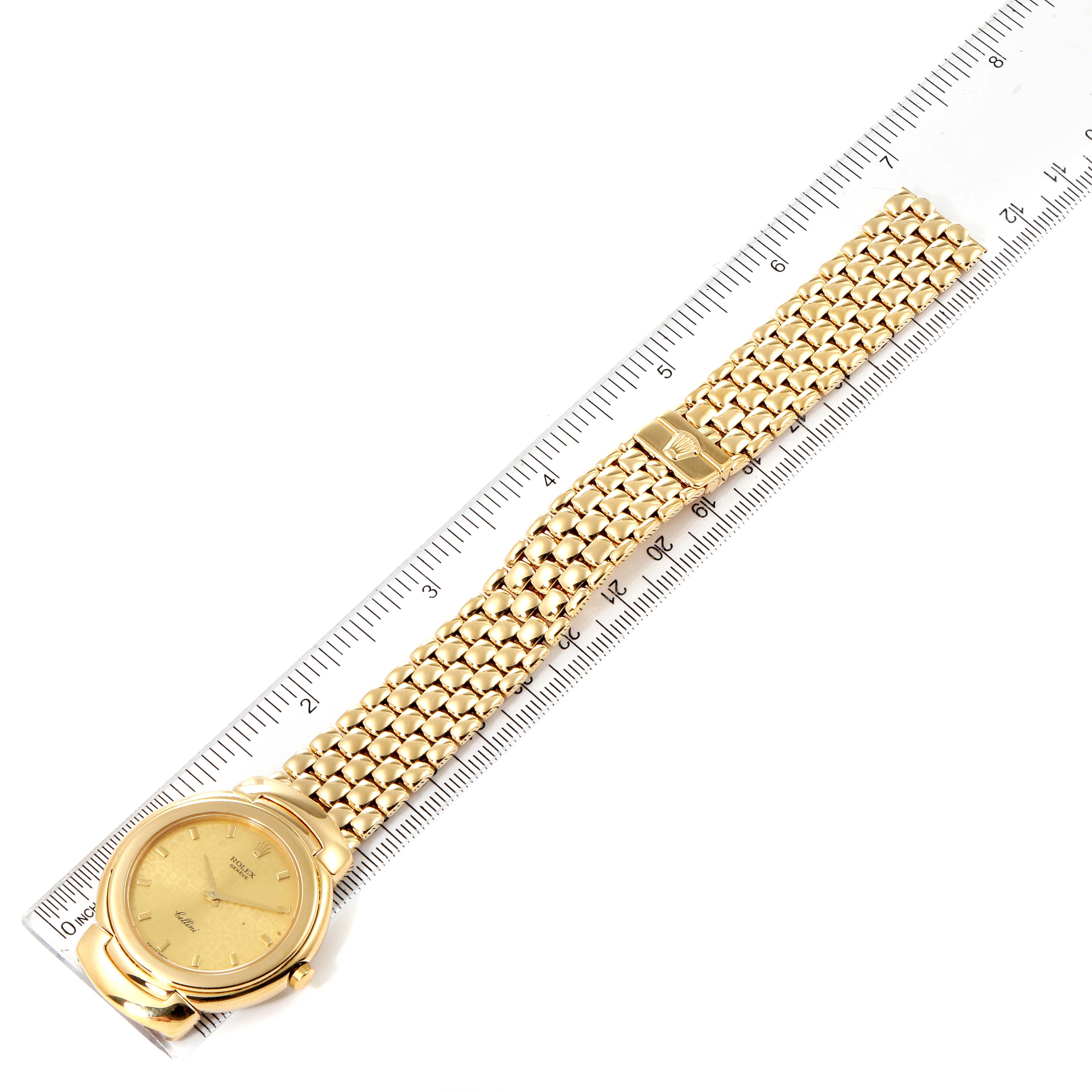 The Rolex Cellini 6622 Men's Yellow Gold Champagne Dial 6622 Men's Yellow Gold Champagne Dial watch is laid flat next to a ruler, displaying the full length of its gold bracelet and round dial.