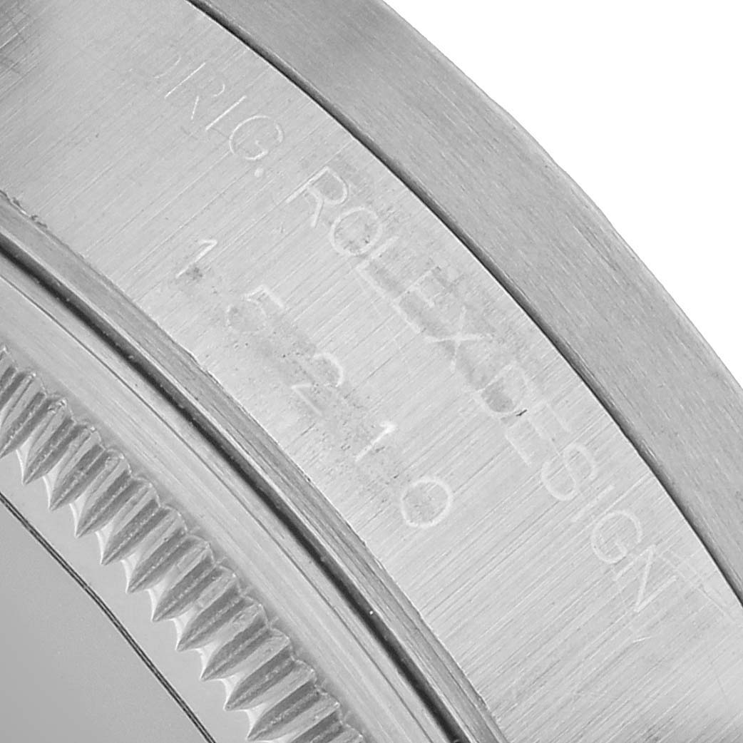 The image shows a close-up of the bezel and the engraved details of a Rolex Date 15210 Men's Stainless Steel Black Dial model watch.