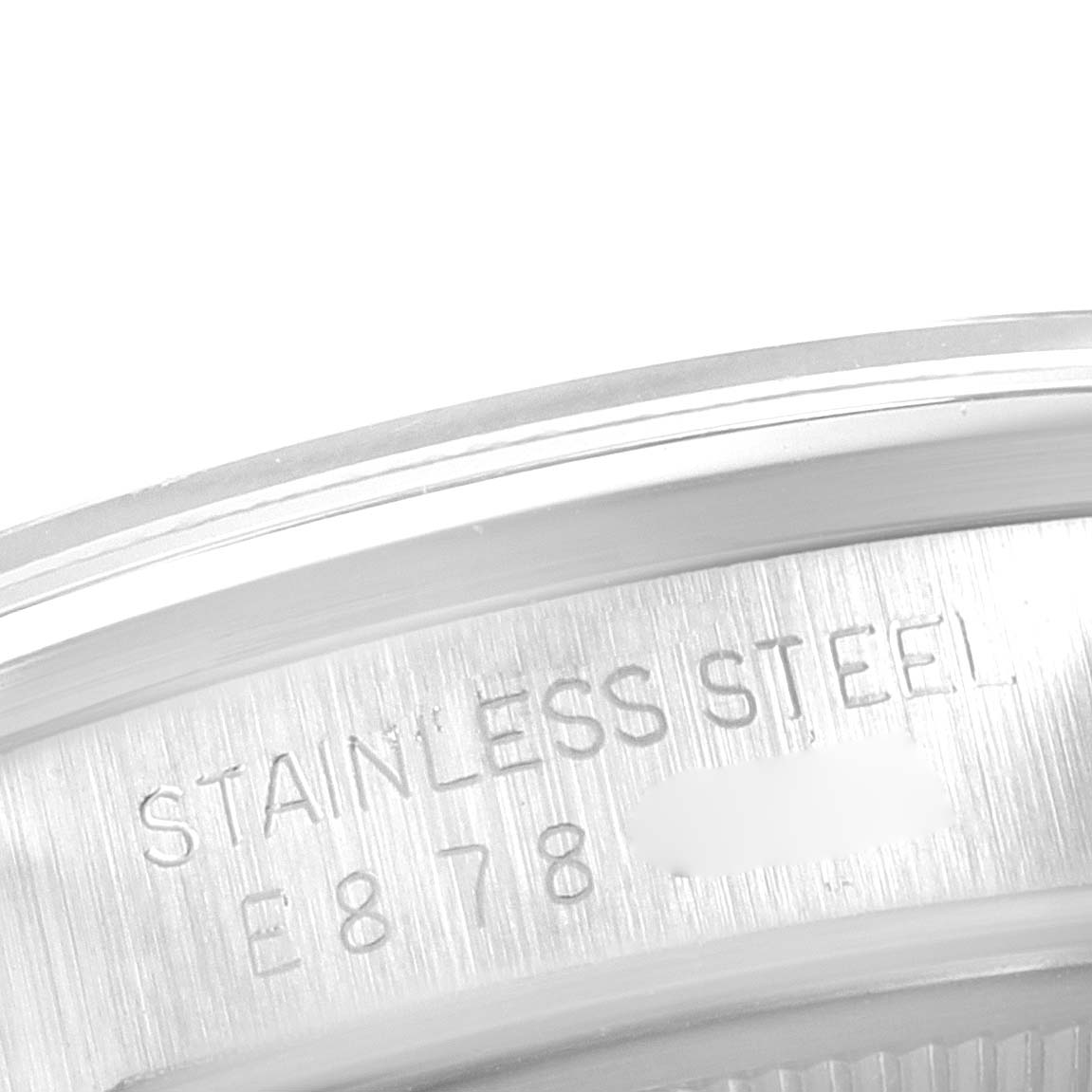 The image shows a close-up of the stainless steel engraving on the case back of a Rolex Date 15200 Men's Stainless Steel Silver Dial 15200 Men's Stainless Steel Silver Dial model watch.