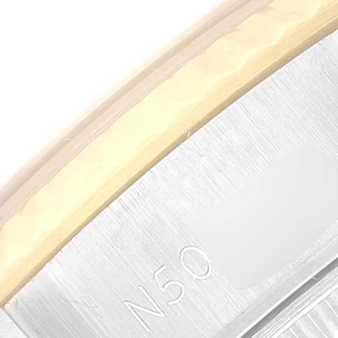 This close-up image shows the edge of the bezel and caseback of a Rolex Datejust 69173 Women's Steel and Gold (two tone) Black Dial 69173 Women's Steel and Gold (two tone) Black Dial watch.