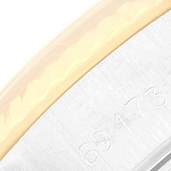 This close-up image of the Rolex Datejust 69173 Women's Steel and Gold (two tone) Black Dial 69173 Women's Steel and Gold (two tone) Black Dial watch shows part of the bezel with engraved numbers.