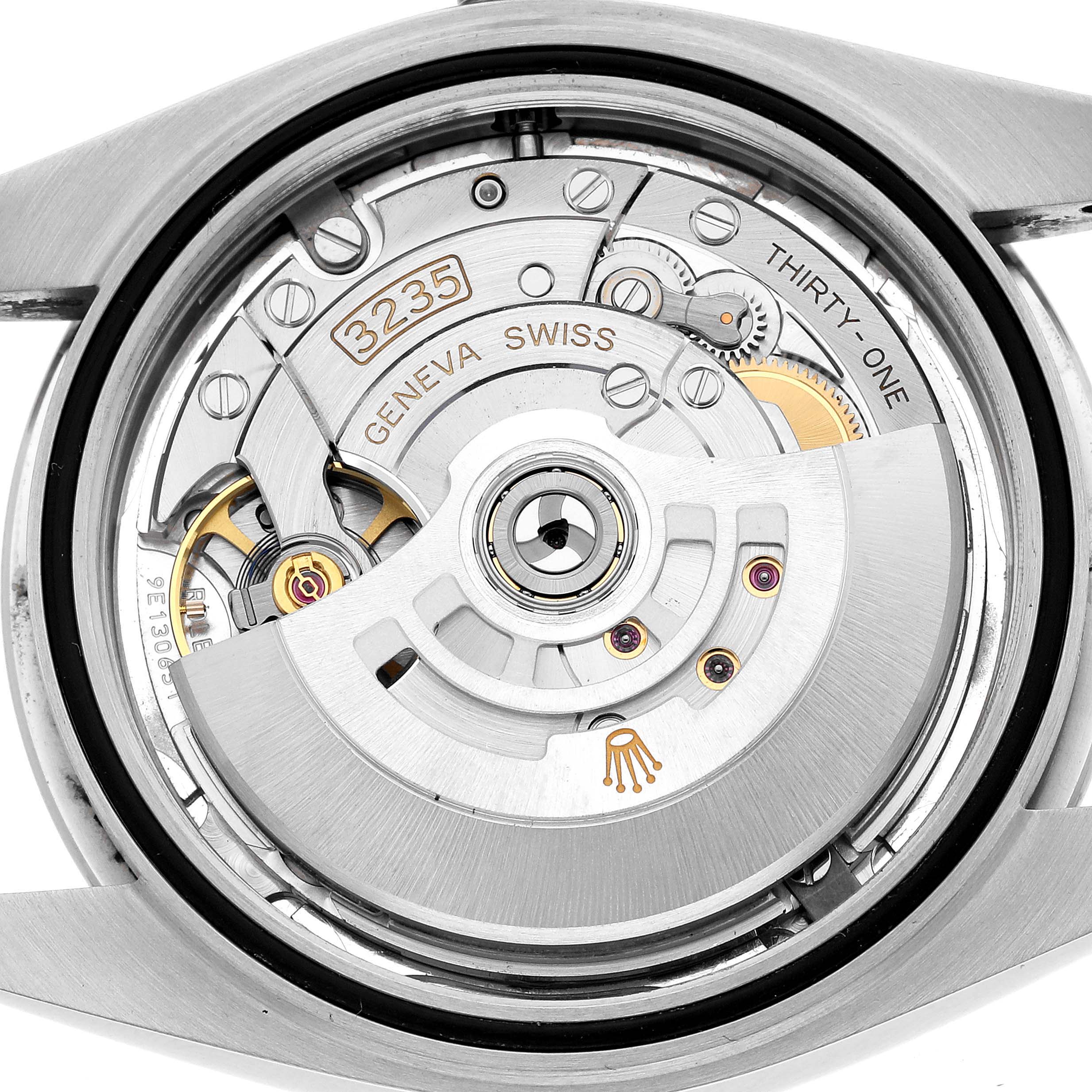 The image shows the movement of a Rolex Datejust 41 126300 Men's Stainless Steel Silver Dial, highlighting the rotor, gears, and Geneva markings from a rear angle.