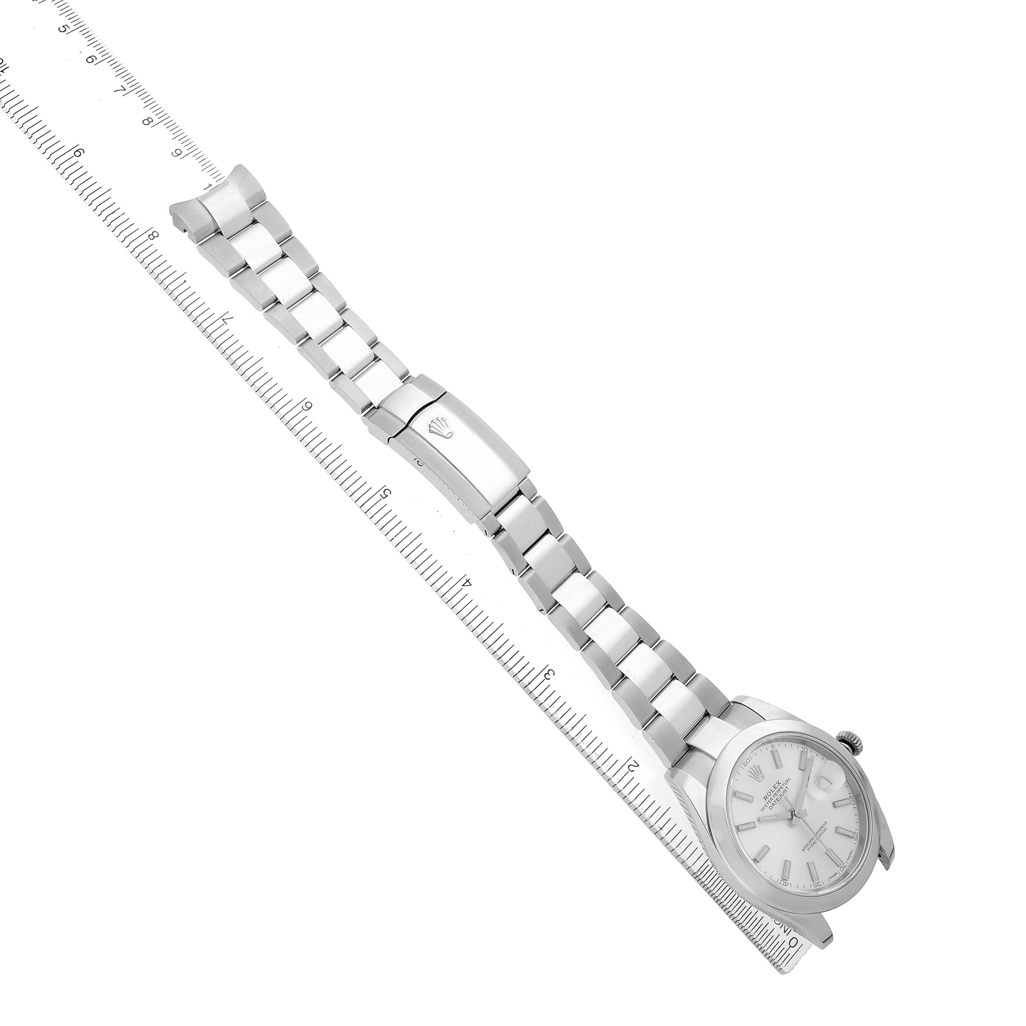 The image shows a Rolex Datejust 41 126300 Men's Stainless Steel Silver Dial watch diagonally, highlighting the band, clasp, and face alongside a ruler for scale.