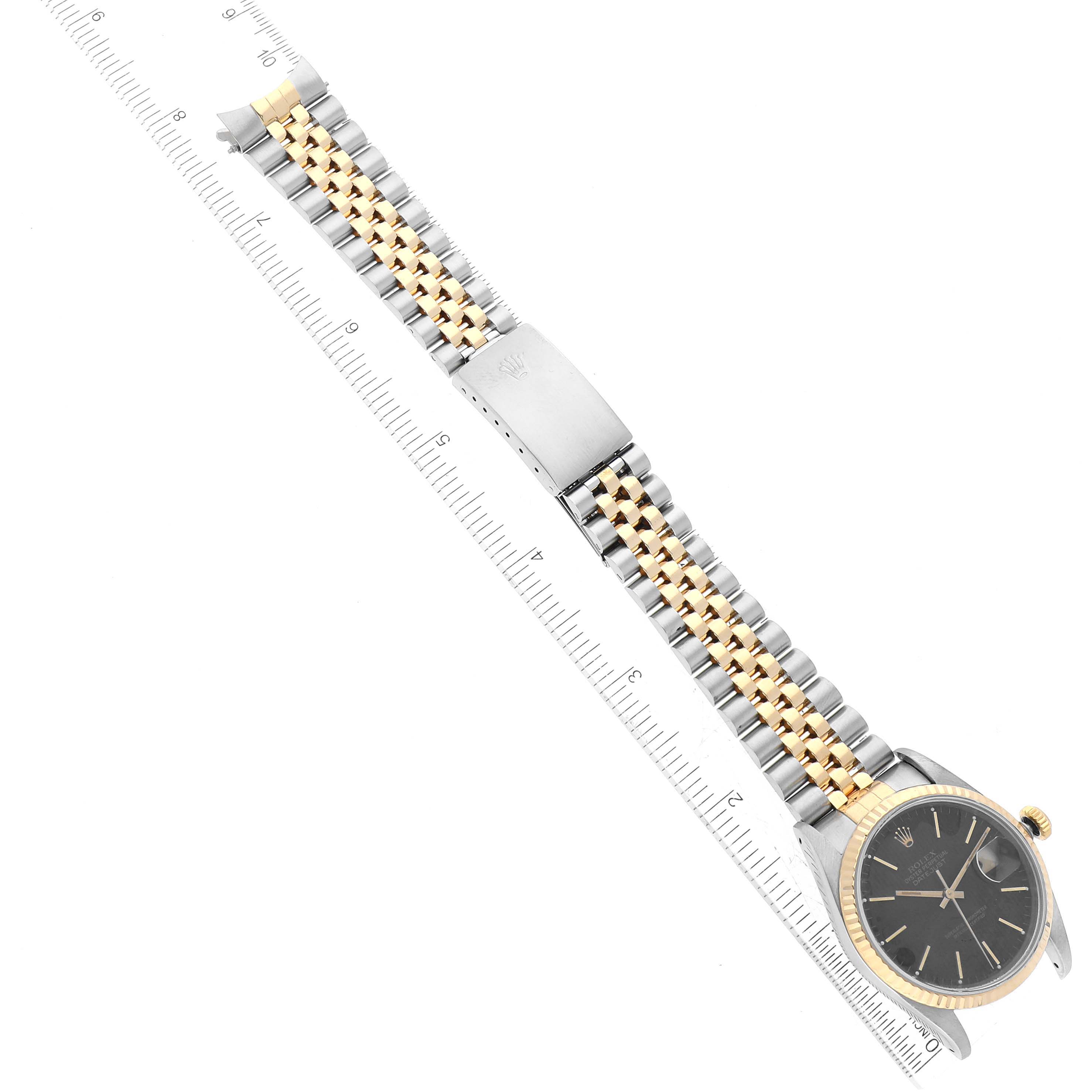 The image shows a Rolex Datejust 16233 Men's Steel and Gold (two tone) Black Dial 16233 Men's Steel and Gold (two tone) Black Dial watch laid horizontally with its entire bracelet and dial visible.