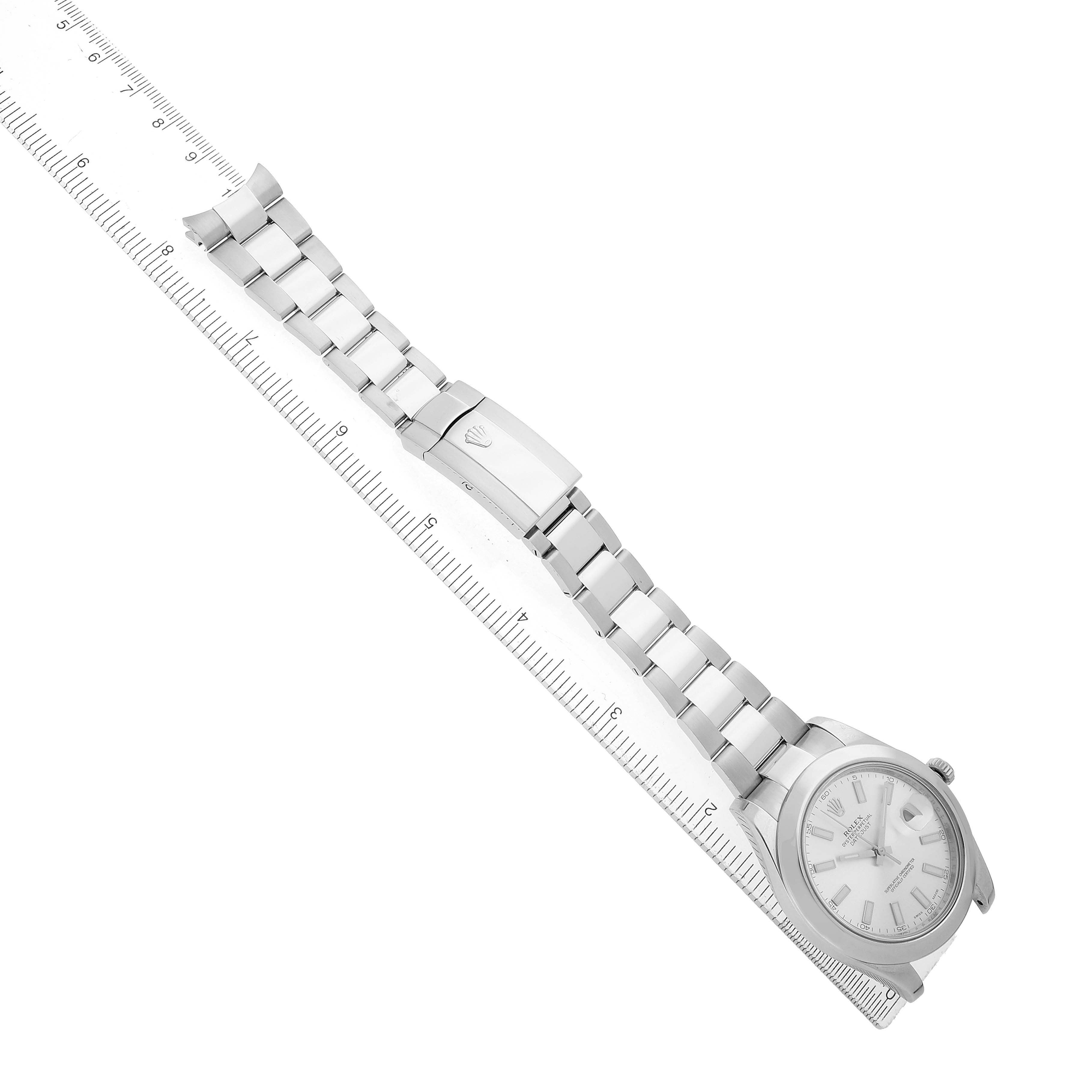 The Rolex Datejust 41 116300 Men's Stainless Steel Silver Dial watch is shown diagonally from an overhead angle, highlighting its bracelet and clasp alongside a ruler.