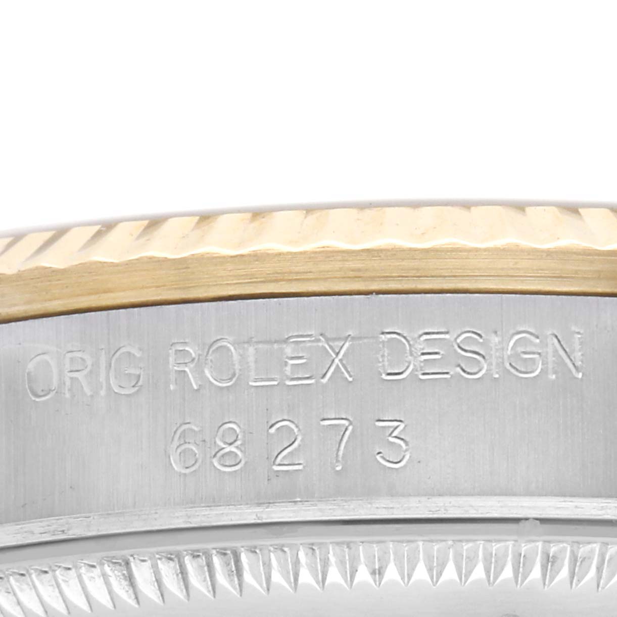 This image shows the side view of a Rolex Mid-Size 68273 Women's Steel and Gold (two tone) Champagne Dial model 68273 focusing on the bezel and engraved design details.