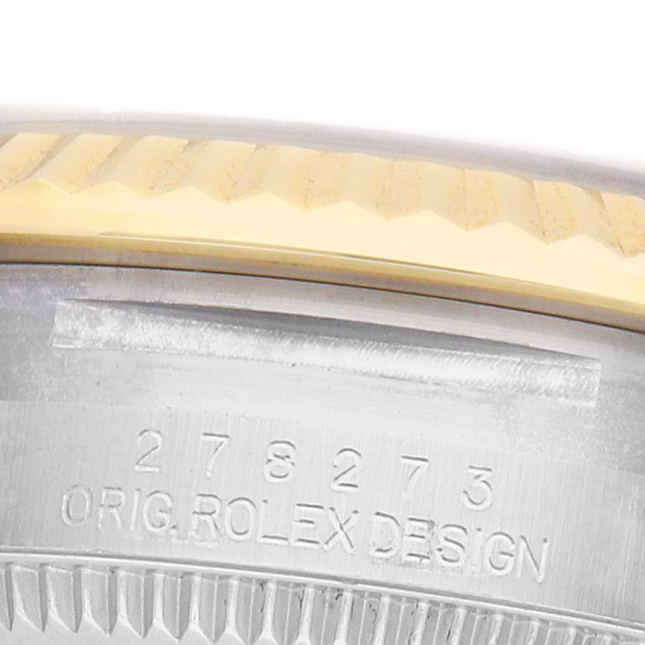 The image shows a close-up of the side of a Rolex Mid-Size 278273 Women's Steel and Gold (two tone) White Dial watch, focusing on the engraved design and part of the bezel.