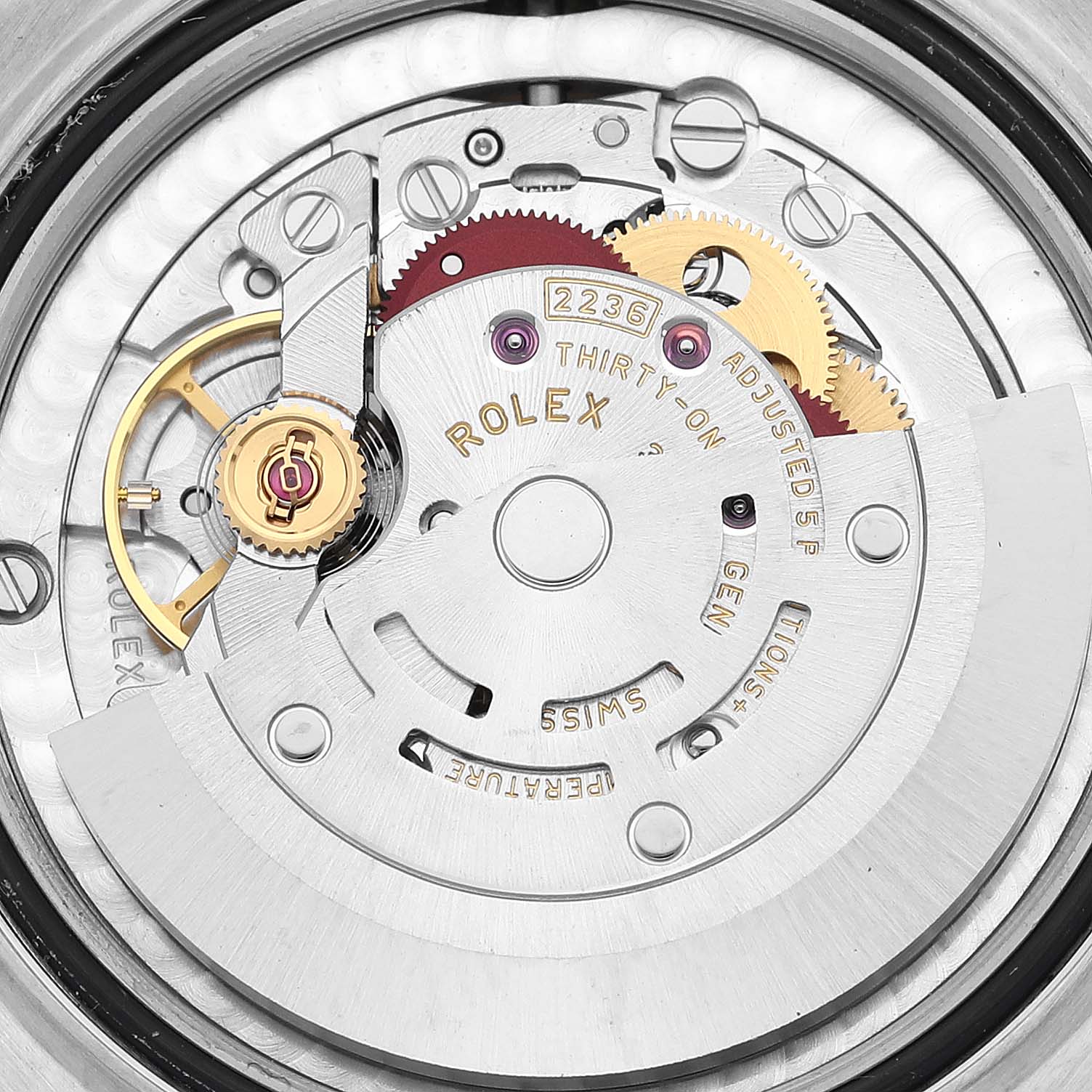 The image shows the movement mechanism of a mid-size Rolex watch, focusing on its intricate internal parts from a macro angle.
