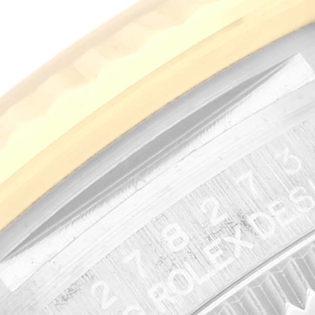 The image shows a close-up of the bezel and part of the rehaut with engravings on a Mid-Size Rolex watch.
