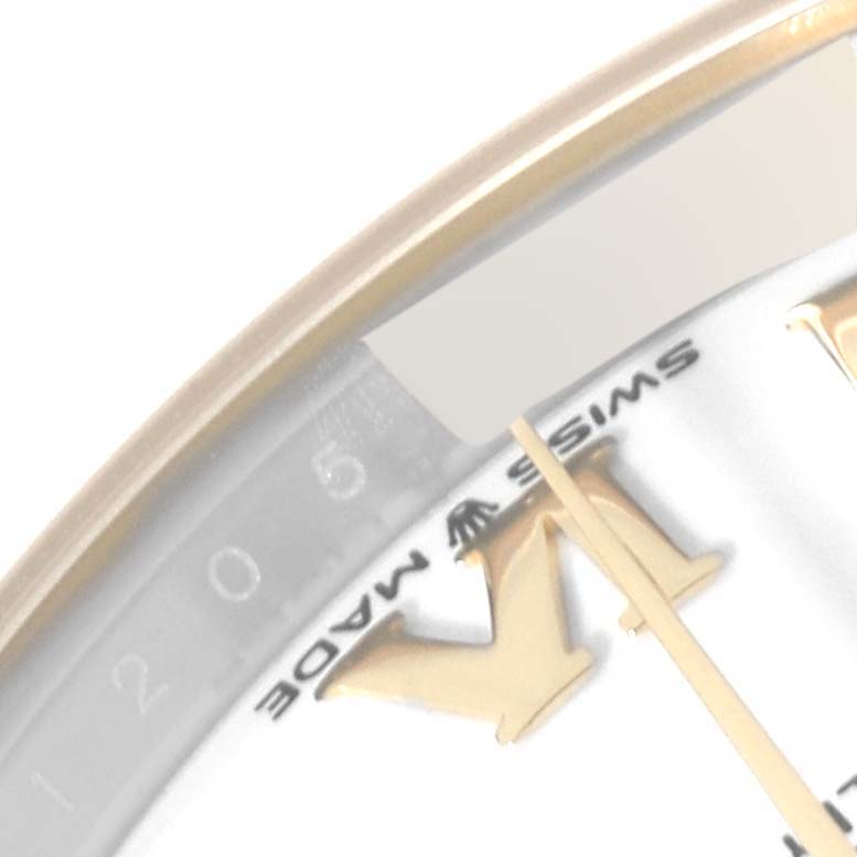 Close-up of the bezel, dial, and Roman numeral markers of a Mid-Size Rolex watch.