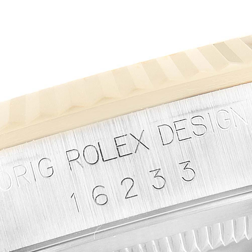 The image shows a close-up of the engraved bezel of a Rolex Datejust 16233 Men's Steel and Gold (two tone) Champagne Dial 16233 Men's Steel and Gold (two tone) Champagne Dial watch, displaying the model number and part of the "Rolex Design" inscription.