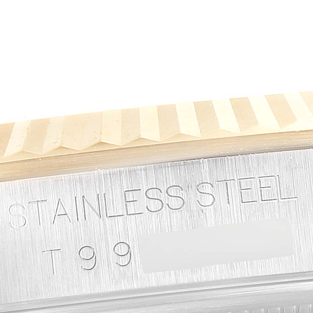 This close-up image of a Rolex Datejust 16233 Men's Steel and Gold (two tone) Champagne Dial 16233 Men's Steel and Gold (two tone) Champagne Dial watch showcases the fluted bezel and the engraved text on the case.