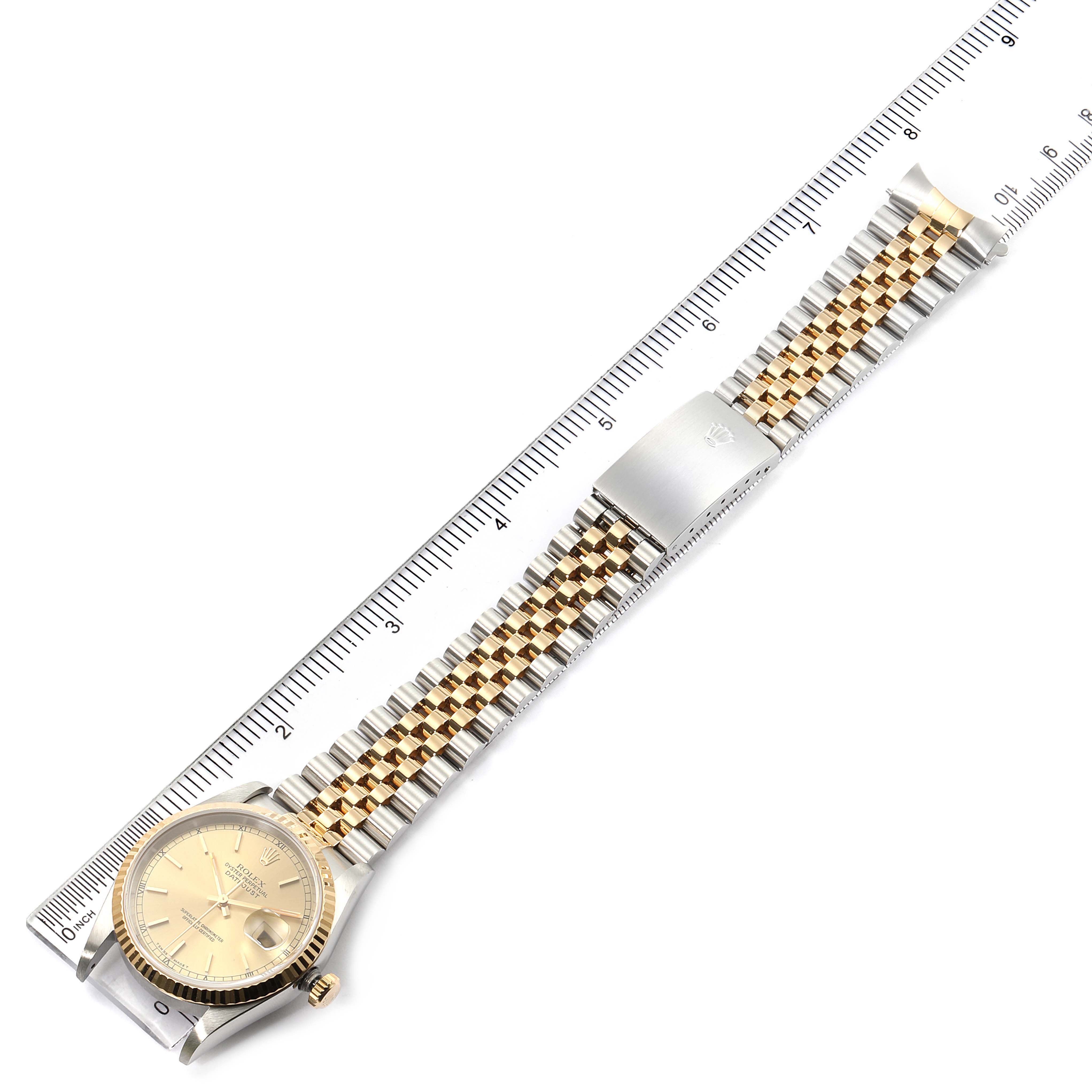 The image shows a Rolex Datejust 16233 Men's Steel and Gold (two tone) Champagne Dial 16233 Men's Steel and Gold (two tone) Champagne Dial watch, including the face, bezel, crown, and two-tone bracelet, laid flat next to a ruler.