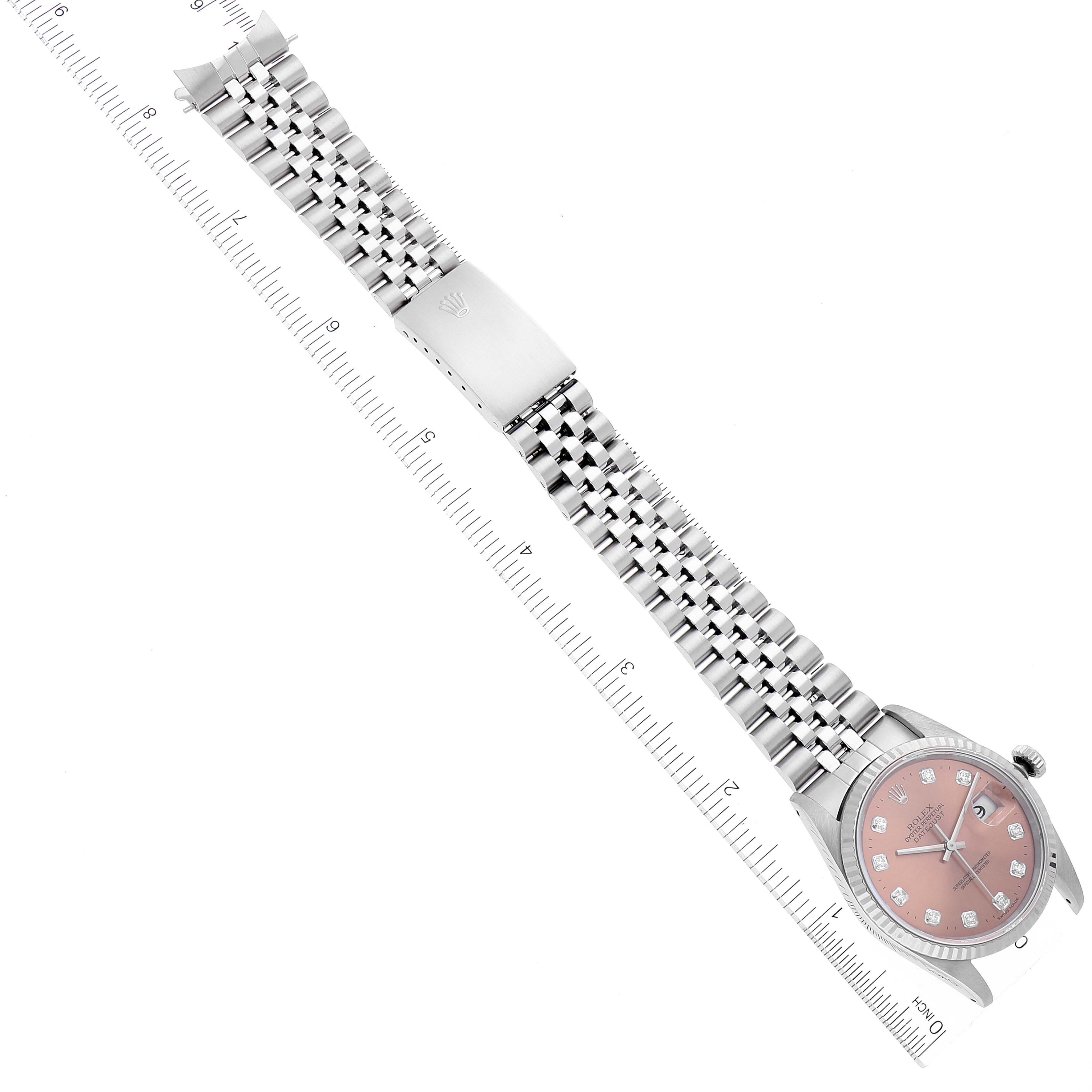 This image shows a Rolex Datejust 16234 Men's Stainless Steel Pink Dial 16234 Men's Stainless Steel Pink Dial watch laid flat, displaying the bracelet, clasp, and dial with rulers on each side.