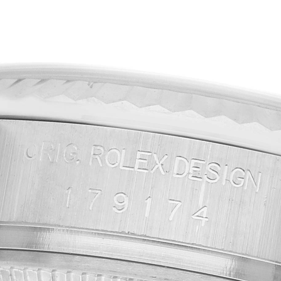 The image shows a close-up of the case edge engraving of a Rolex Datejust 179174 Women's Stainless Steel Silver Dial model, featuring the design and serial number.