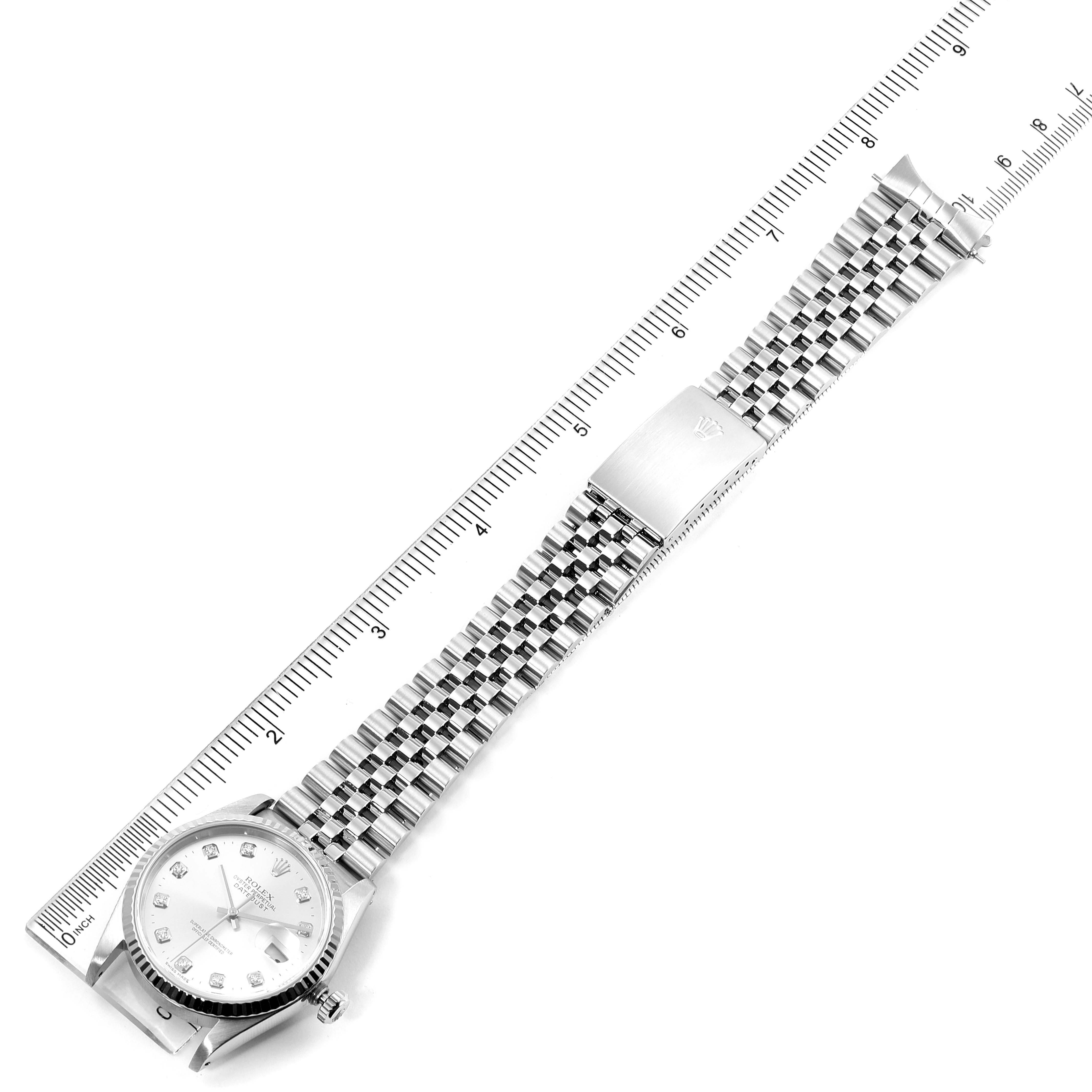 The image shows a top-down view of a Rolex Datejust 16234 Men's Stainless Steel Silver Dial 16234 Men's Stainless Steel Silver Dial watch with its full metal bracelet extended alongside a ruler.
