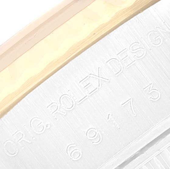 This close-up image shows part of the engraved casing on a Rolex Datejust 69173 Women's Steel and Gold (two tone) Beige Dial 69173 Women's Steel and Gold (two tone) Beige Dial watch.