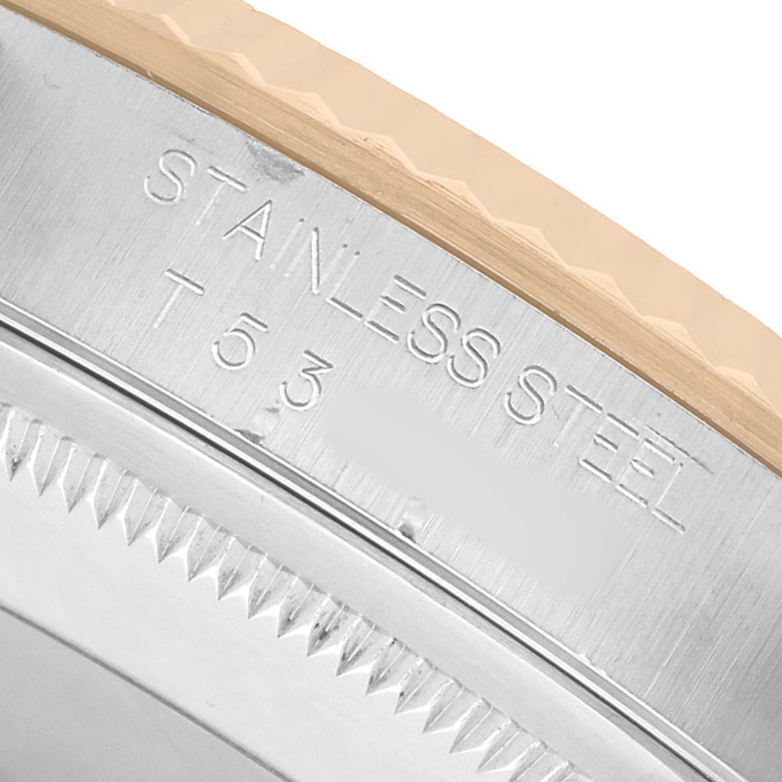 The image shows a close-up of the Rolex Datejust 16233 Men's Steel and Gold (two tone) Champagne Dial's stainless steel watch edge and part of the bezel.