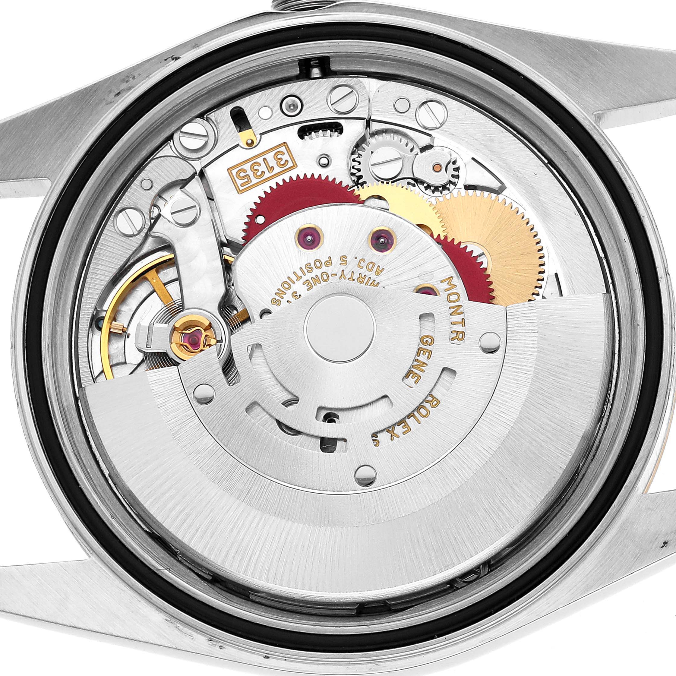 The image shows a close-up view of the Rolex Datejust 16233 Men's Steel and Gold (two tone) Champagne Dial watch's movement from the back, highlighting gears and the rotor.