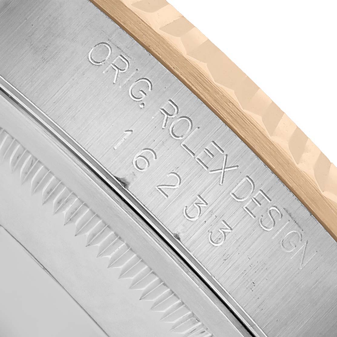 The image shows a close-up of the case side and bezel edge of a Rolex Datejust 16233 Men's Steel and Gold (two tone) Champagne Dial watch, highlighting engraved details.
