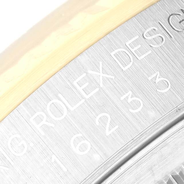 This close-up image shows part of the stainless steel bezel of the Rolex Datejust 16233 Men's Steel and Gold (two tone) Silver Dial 16233 Men's Steel and Gold (two tone) Silver Dial, highlighting the engraved text and edge of the case.