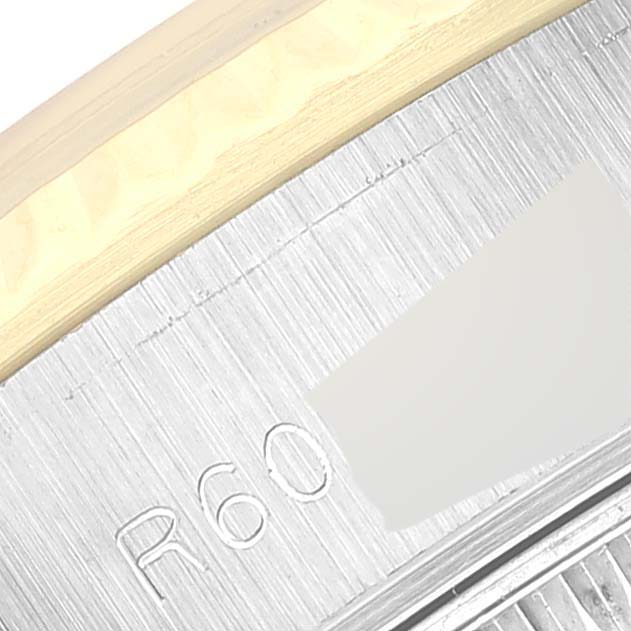 This image shows a close-up of the side detail and partial inscription on the Rolex Datejust 69173 Women's Steel and Gold (two tone) Champagne Dial 69173 Women's Steel and Gold (two tone) Champagne Dial model.