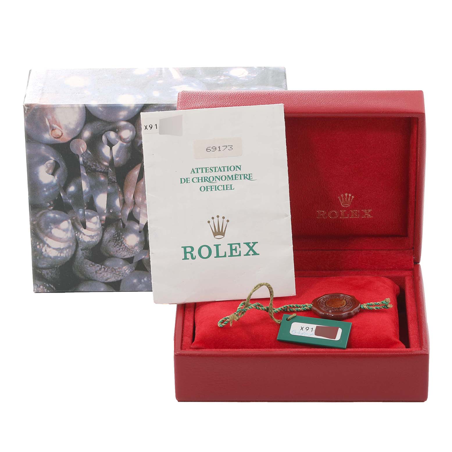 The image shows the accessories for a Rolex Datejust 69173 Women's Steel and Gold (two tone) Champagne Dial 69173 Women's Steel and Gold (two tone) Champagne Dial, including an official certificate, tag, and a red box.