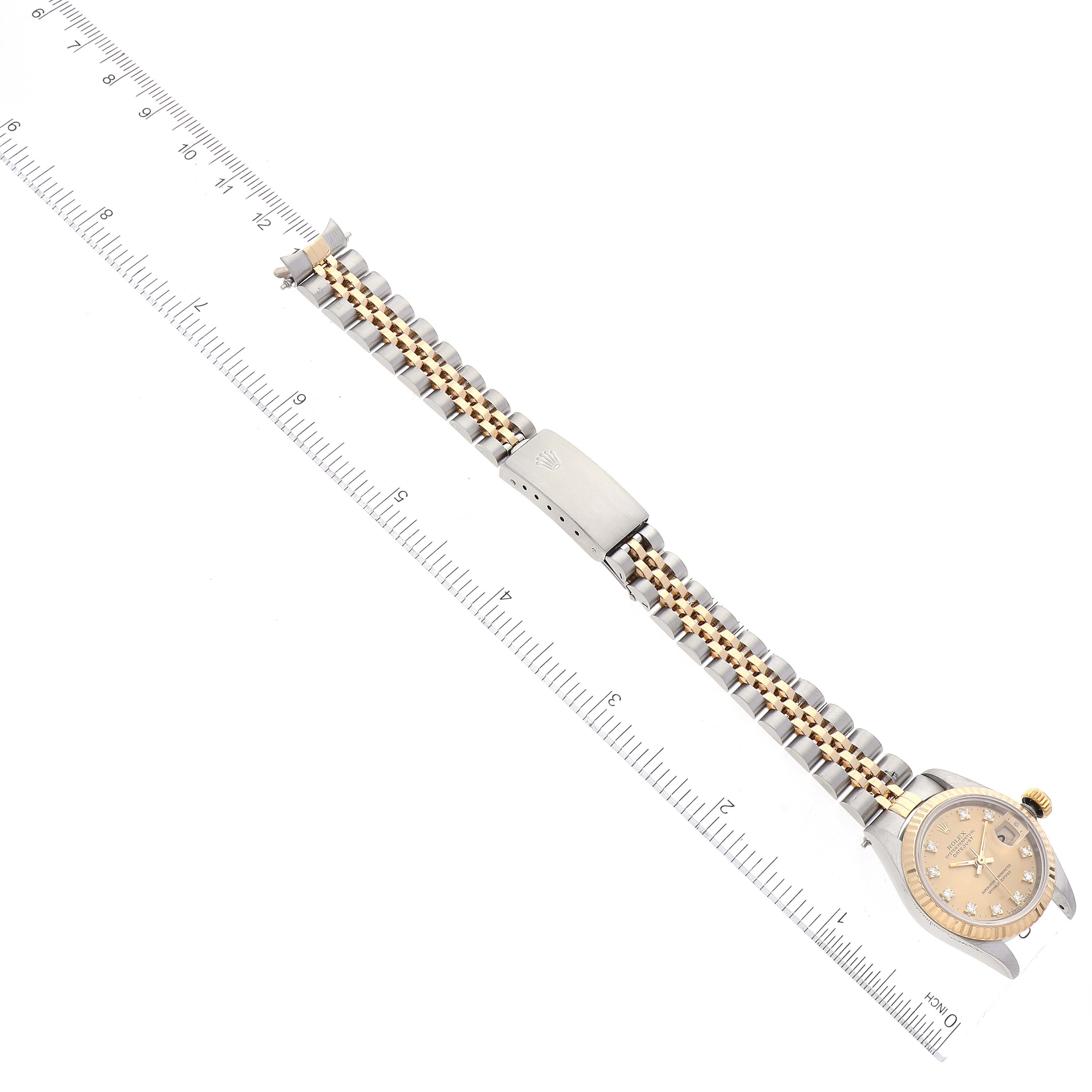 The image shows a Rolex Datejust 69173 Women's Steel and Gold (two tone) Champagne Dial 69173 Women's Steel and Gold (two tone) Champagne Dial model watch laid flat alongside a ruler, displaying the entire strap and face from above.