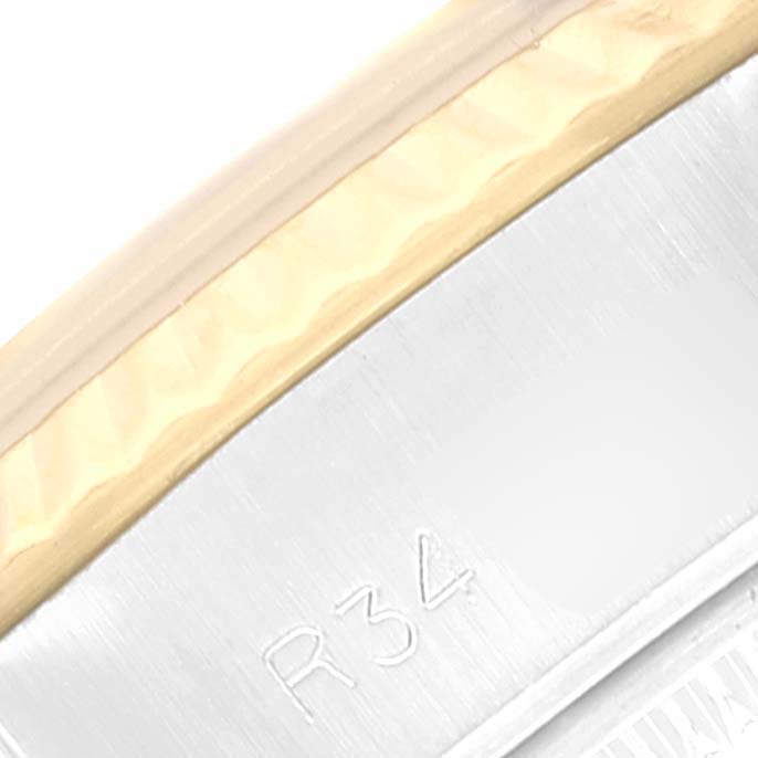 This image shows a close-up of the bezel and part of the case back of a Rolex Datejust 69173 Women's Steel and Gold (two tone) Champagne Dial 69173 Women's Steel and Gold (two tone) Champagne Dial watch.