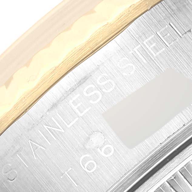 The image shows a close-up of a stainless steel and gold section of a Rolex Datejust 69173 Women's Steel and Gold (two tone) Silver Dial 69173 Women's Steel and Gold (two tone) Silver Dial watch caseback.
