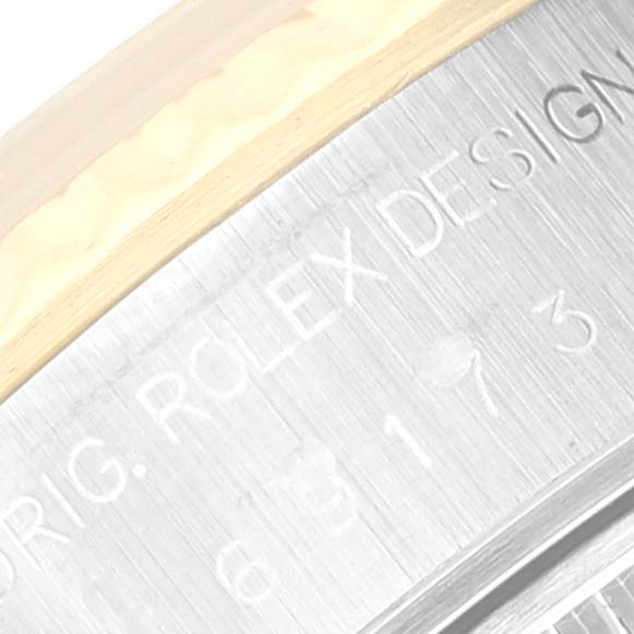 The image shows a close-up of the engraved text on the side of the Rolex Datejust 69173 Women's Steel and Gold (two tone) Silver Dial 69173 Women's Steel and Gold (two tone) Silver Dial watch case.