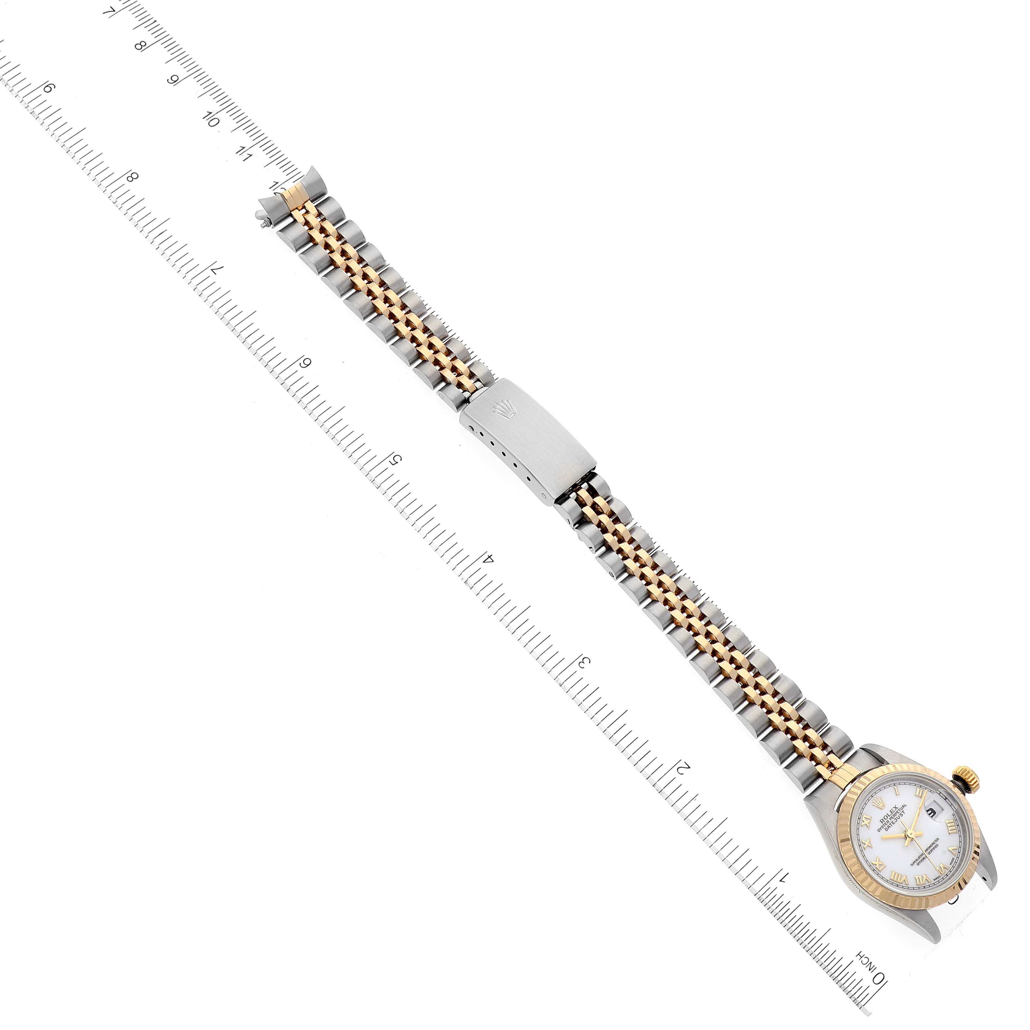 The Rolex Datejust 69173 Women's Steel and Gold (two tone) White Dial 69173 Women's Steel and Gold (two tone) White Dial watch is shown from a top-down angle, displaying the dial and bracelet alongside a ruler for scale.