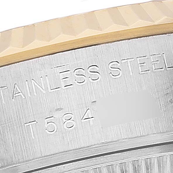 This close-up image of a Rolex Datejust 69173 Women's Steel and Gold (two tone) White Dial 69173 Women's Steel and Gold (two tone) White Dial watch shows the stainless steel case and part of the fluted bezel.