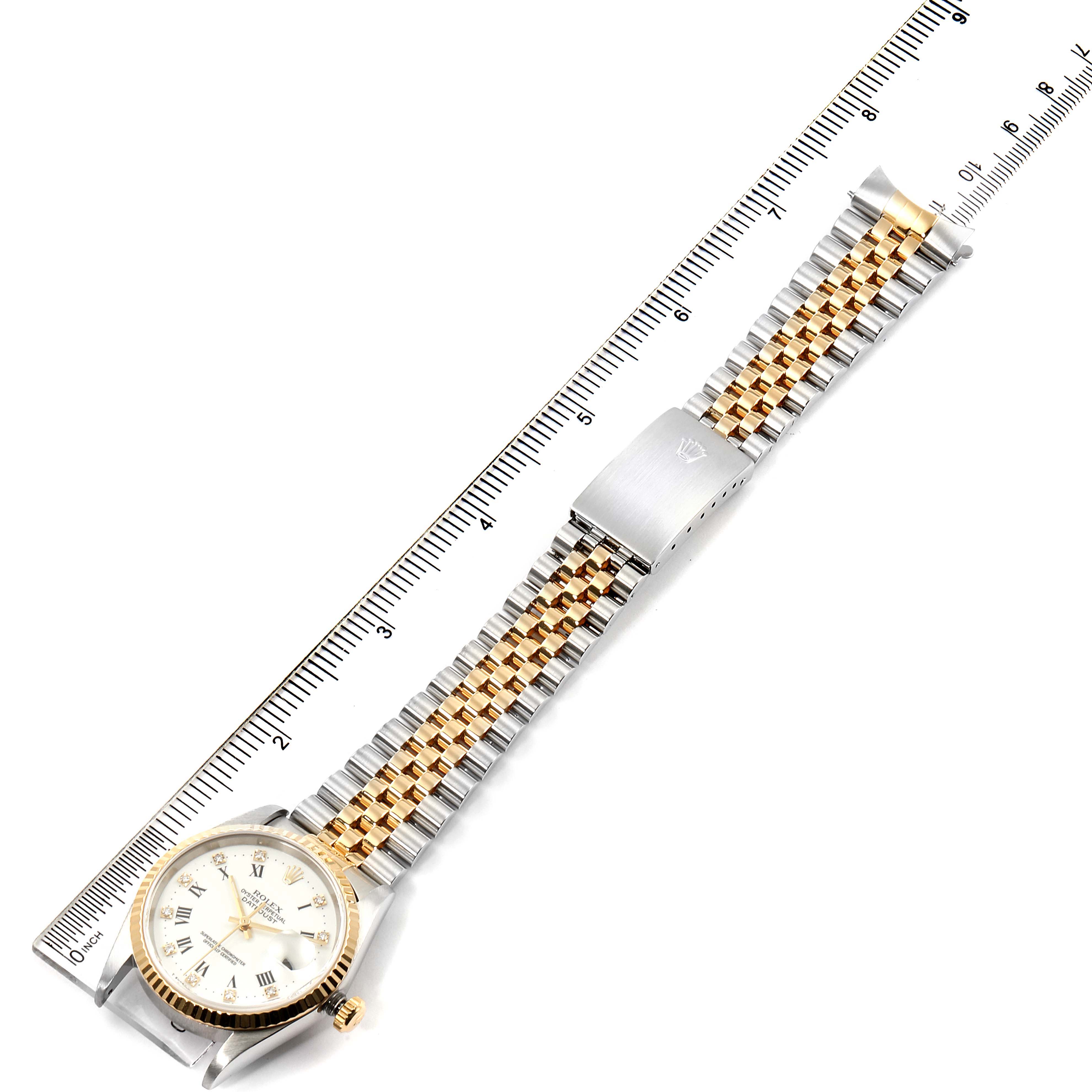 The image shows a top-down view of a Rolex Datejust 16233 Men's Steel and Gold (two tone) White Dial 16233 Men's Steel and Gold (two tone) White Dial watch, including the face, bezel, crown, and part of the bracelet with a clasp.
