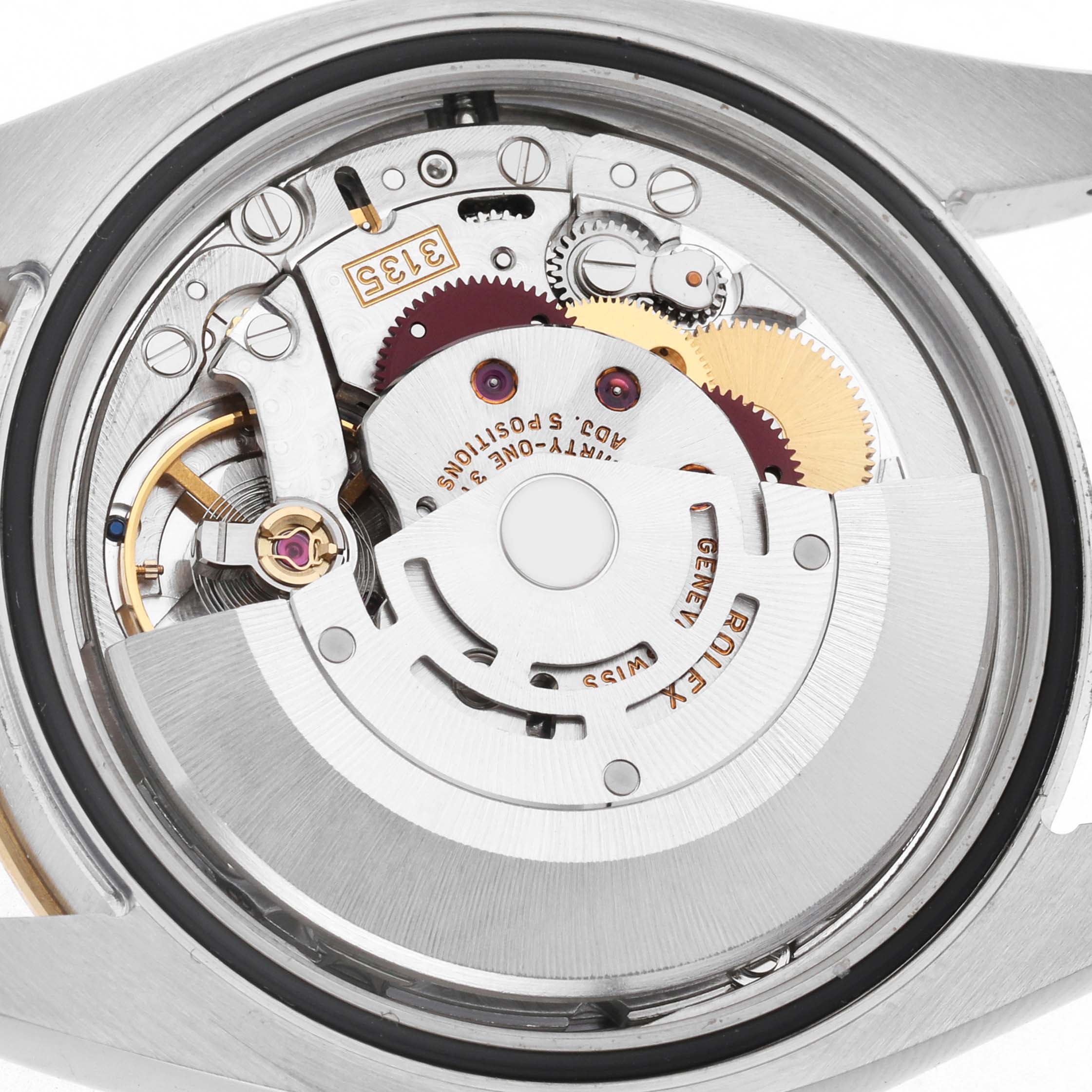 The image shows the back view of a Rolex Turn-o-Graph 116263 Men's Steel and Gold (two tone) Champagne Dial watch, highlighting its intricate movement and gears.