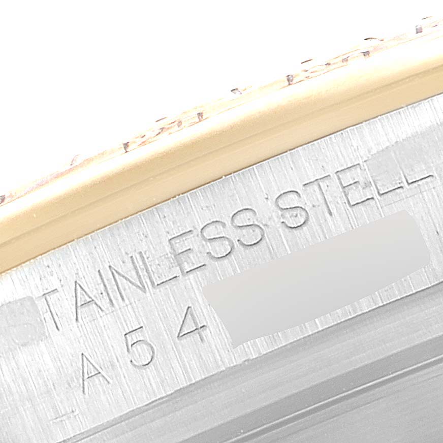 This is a close-up image of the case side of a Rolex Daytona 16523 Men
s Steel and Gold (two tone) Champagne Dial 16523 Men
s Steel and Gold (two tone) Champagne Dial watch, showing the "STAINLESS STEEL" engraving.