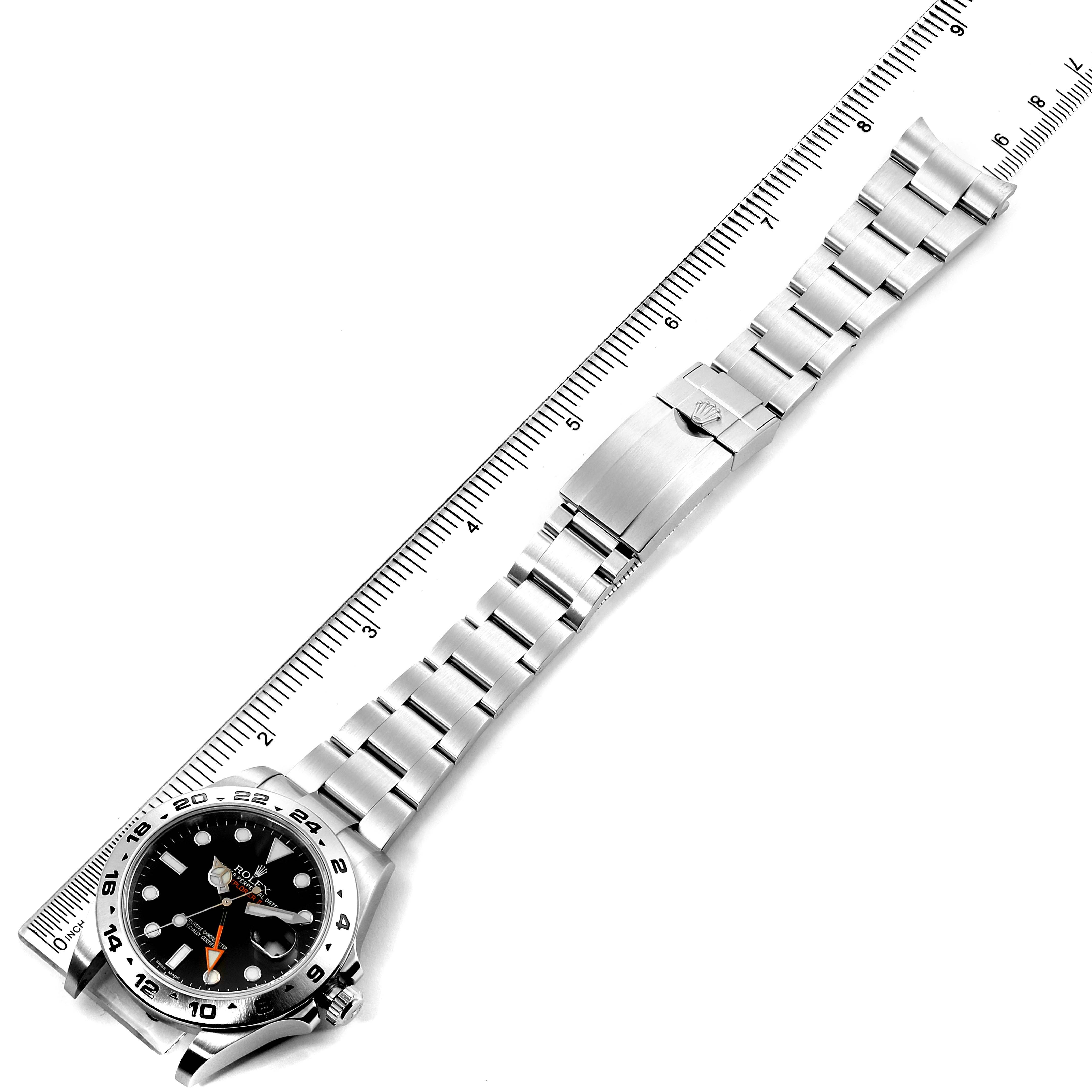 The image shows the Rolex Explorer 216570 Men
s Stainless Steel Black Dial 216570 Men
s Stainless Steel Black Dial watch laid flat with its band extended, measured by a ruler.