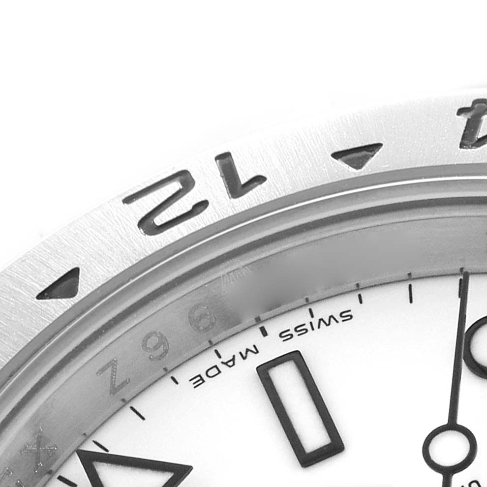 The image shows a close-up of the dial and a partial bezel of the Rolex Explorer 16570 Men's Stainless Steel White Dial, highlighting the "Swiss Made" text and part of the numeral "12".