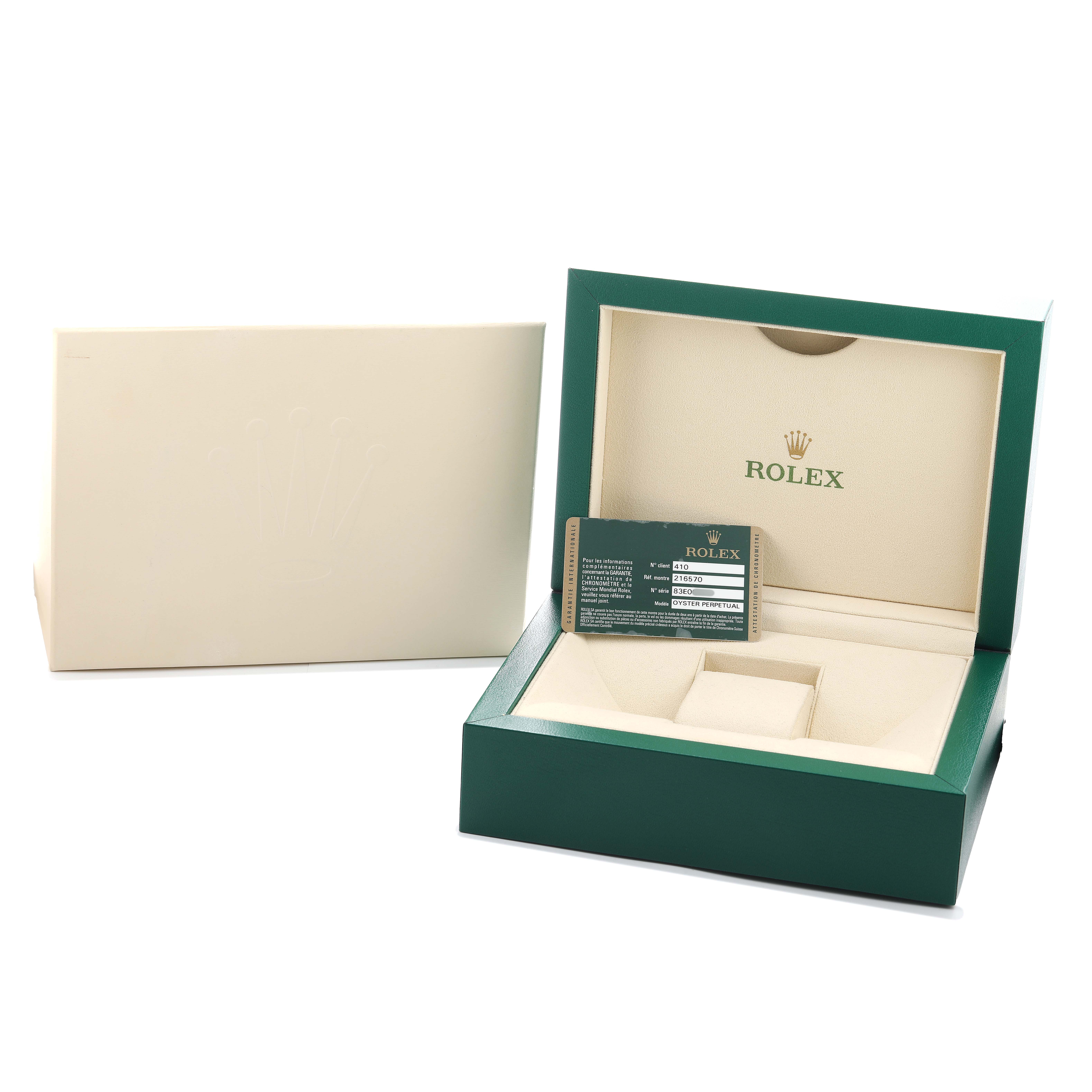 The image shows the open box and card of a Rolex Explorer 216570 Men's Stainless Steel White Dial, with the exterior packaging also visible.
