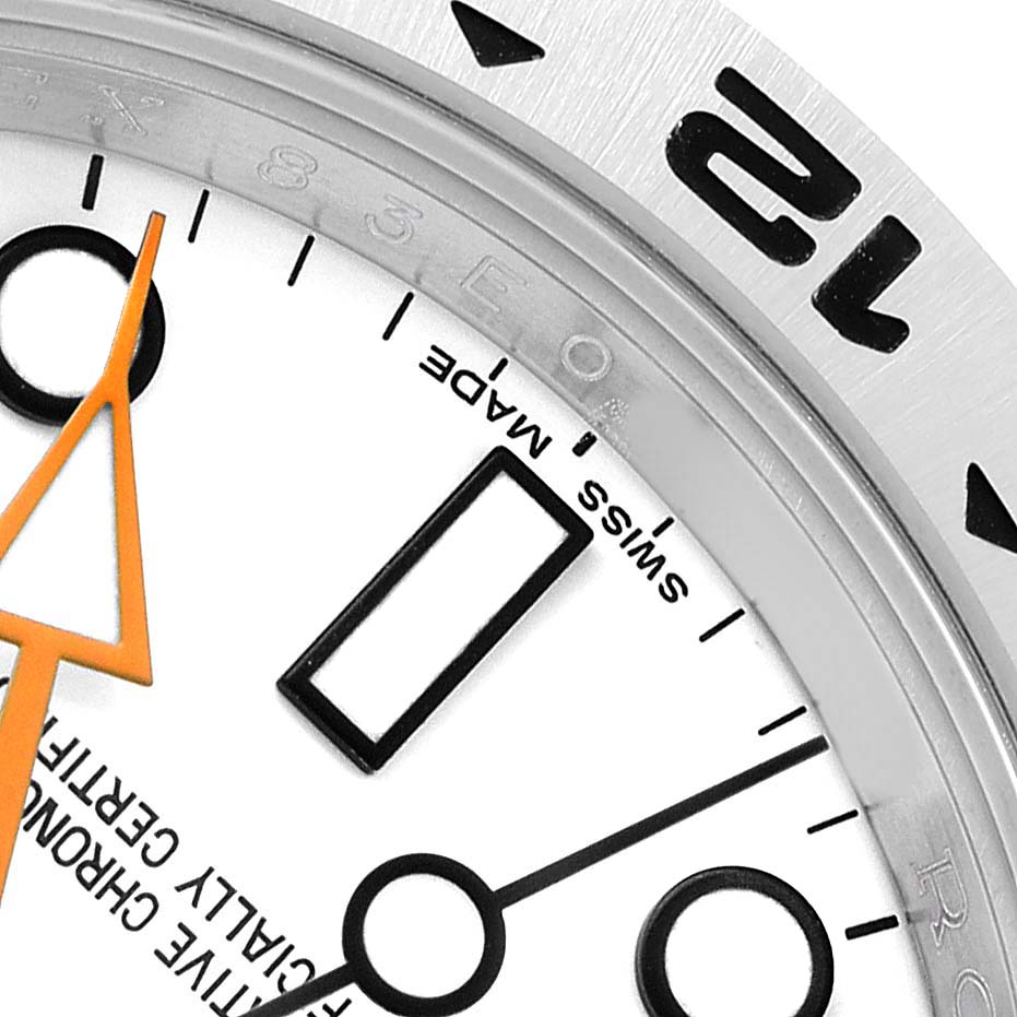 The image shows a close-up of the Rolex Explorer 216570 Men's Stainless Steel White Dial's dial and bezel at an angle, highlighting the hour markers, hands, and part of the "Swiss Made" text.