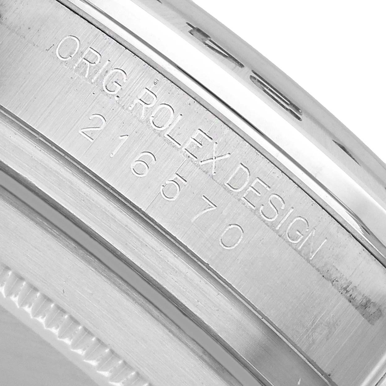 The image shows the case side of the Rolex Explorer 216570 Men's Stainless Steel White Dial, featuring its engraved design and model number.