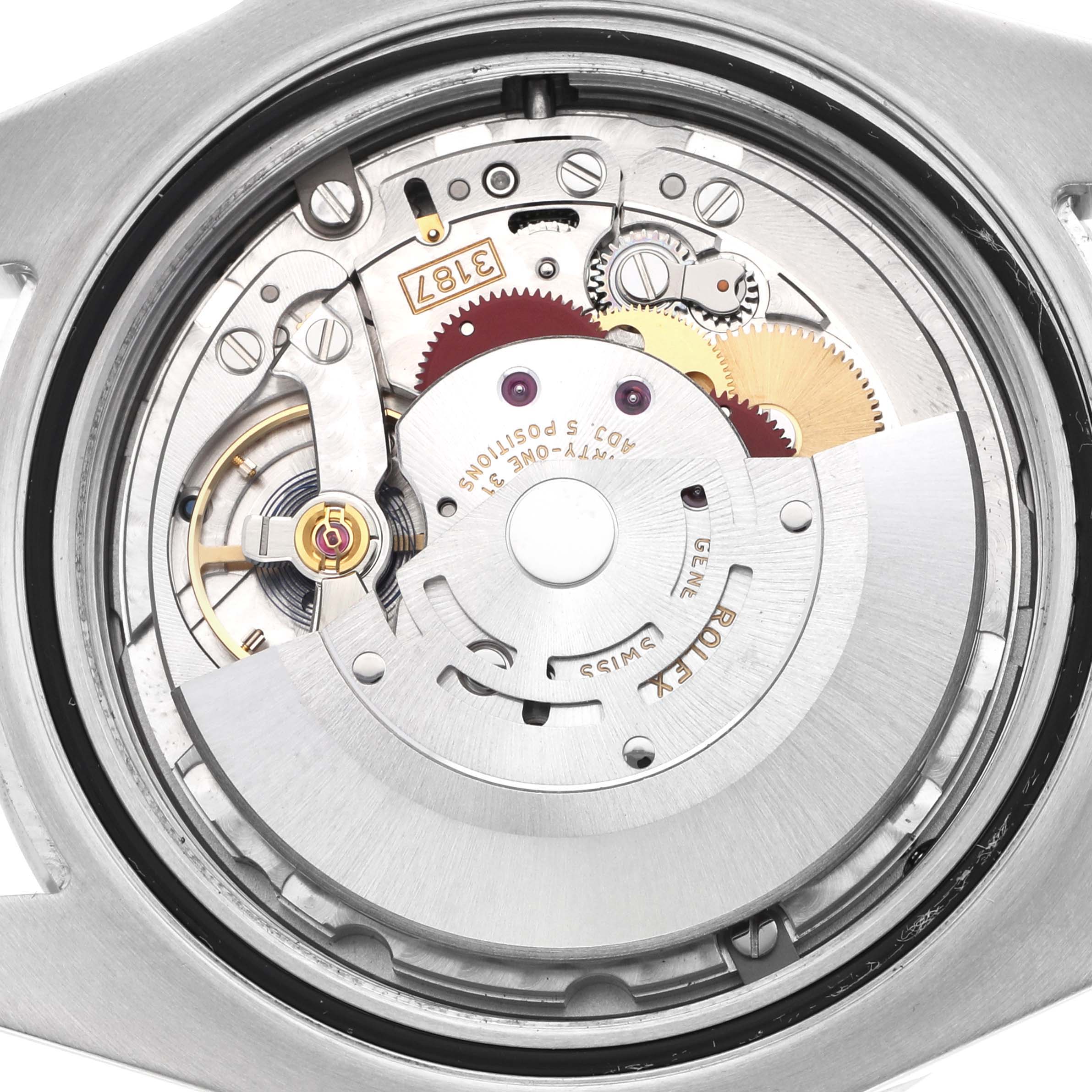 The image shows the movement of a Rolex Explorer 216570 Men's Stainless Steel White Dial watch, focusing on its internal mechanism from the back.