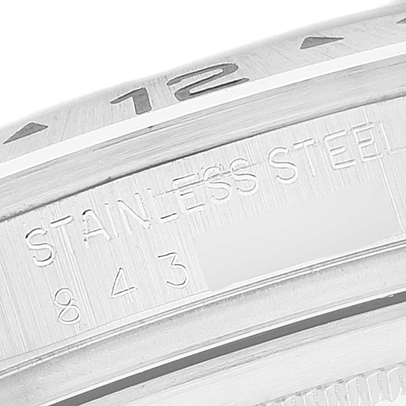 The image shows a close-up of the stainless steel bezel and case edge of a Rolex Explorer 16550 Men's Stainless Steel Black Dial 16550 Men's Stainless Steel Black Dial watch, featuring the "STAINLESS STEEL" engraving and part of the number 12.