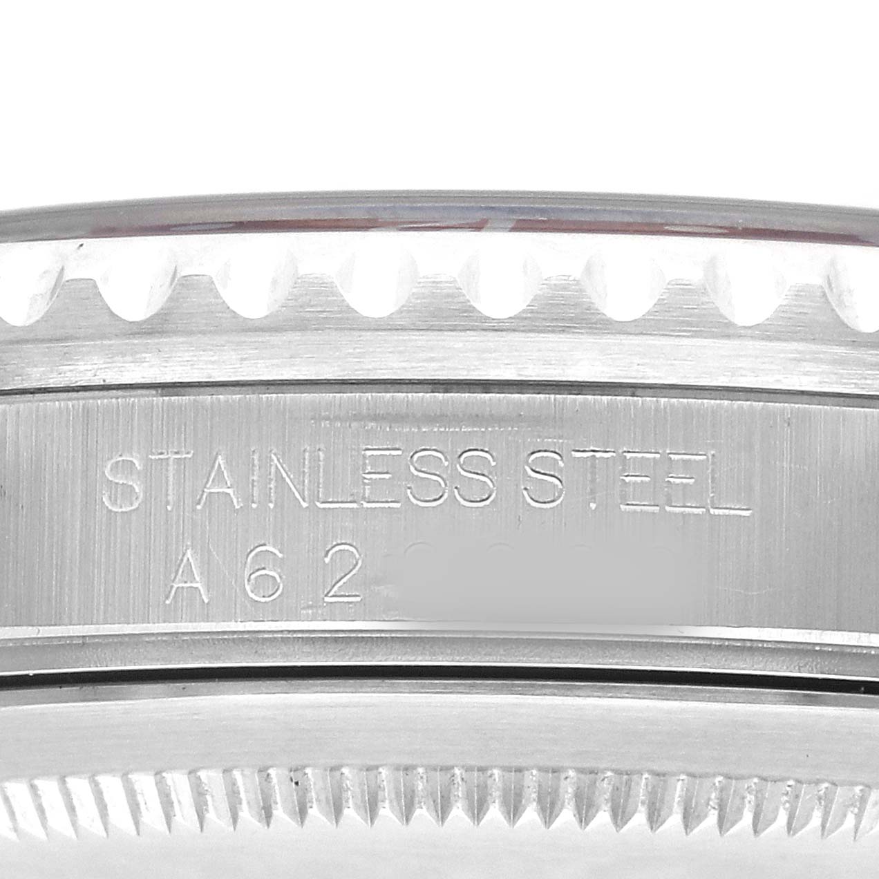 The image shows a close-up of the side of a Rolex GMT-Master 16700 Men's Stainless Steel Black Dial watch, showcasing the stainless steel engraving on the case.