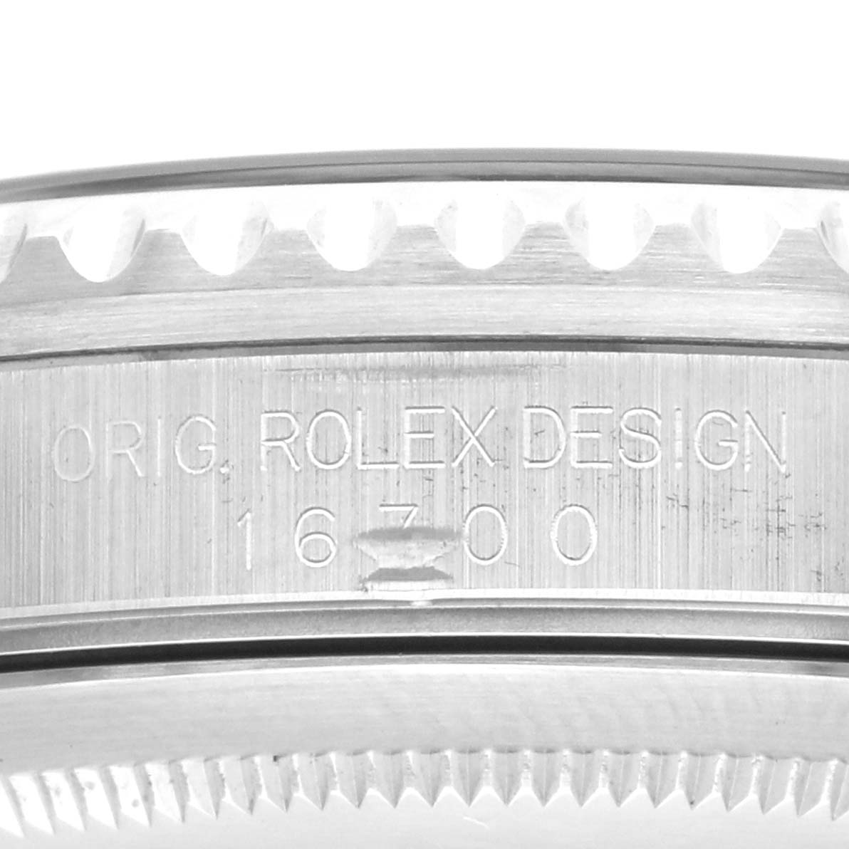 The image shows a close-up of the case side of a Rolex GMT-Master 16700 Men's Stainless Steel Black Dial, highlighting the model number engraving.