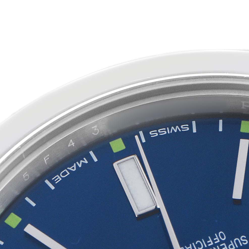 This image shows a partial view of the Rolex Oyster Perpetual 114300 Men's Stainless Steel Blue Dial watch face, focusing on the edge with indices and part of the dial.