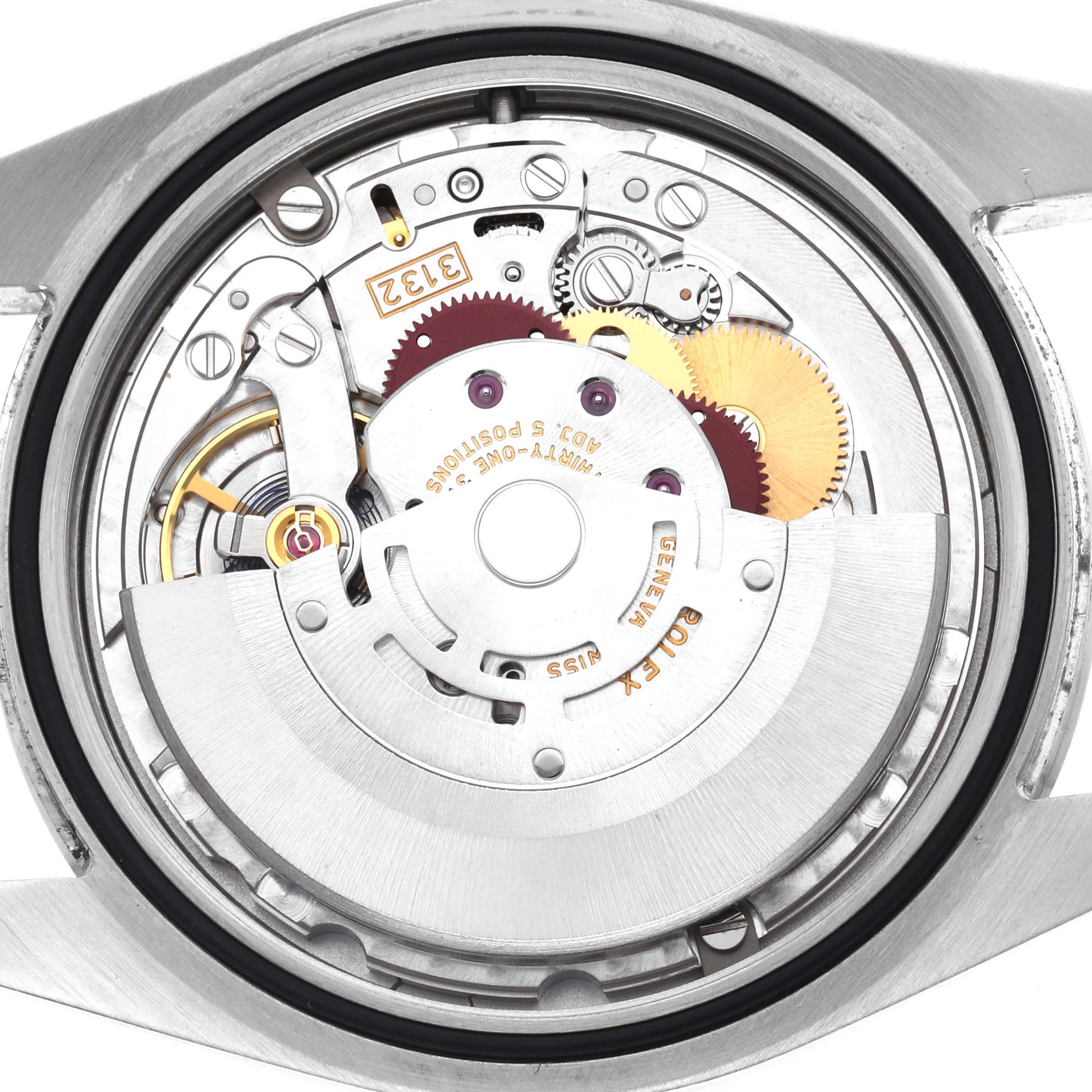 The image shows the movement of a Rolex Oyster Perpetual 114300 Men's Stainless Steel Blue Dial watch from a rear angle, highlighting its intricate mechanical components.