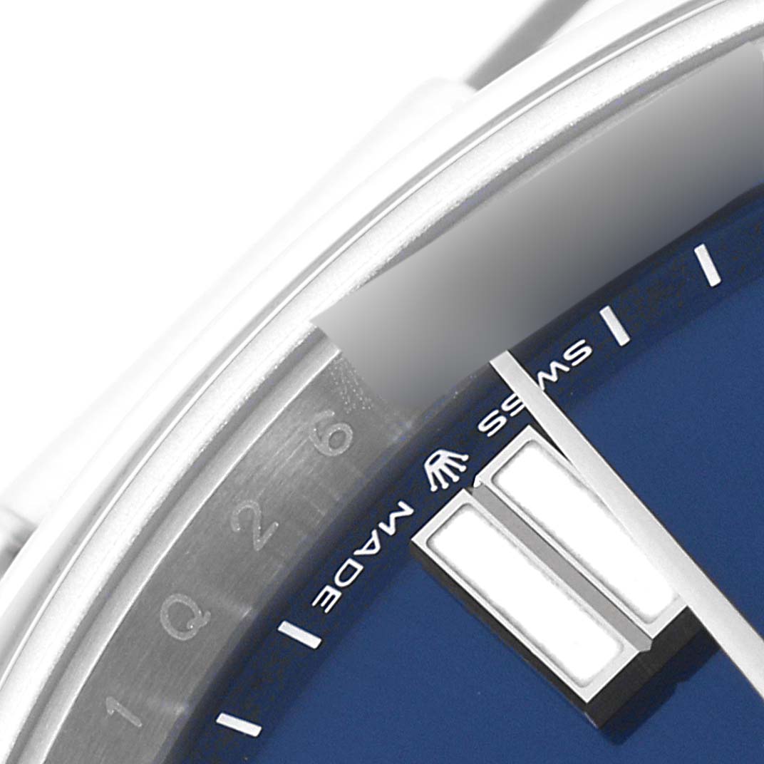 This close-up image of a Rolex Oyster Perpetual 124300 Men
s Stainless Steel Blue Dial 124300 Men
s Stainless Steel Blue Dial watch shows a partial view of the dial, hour markers, and the "Swiss Made" text.