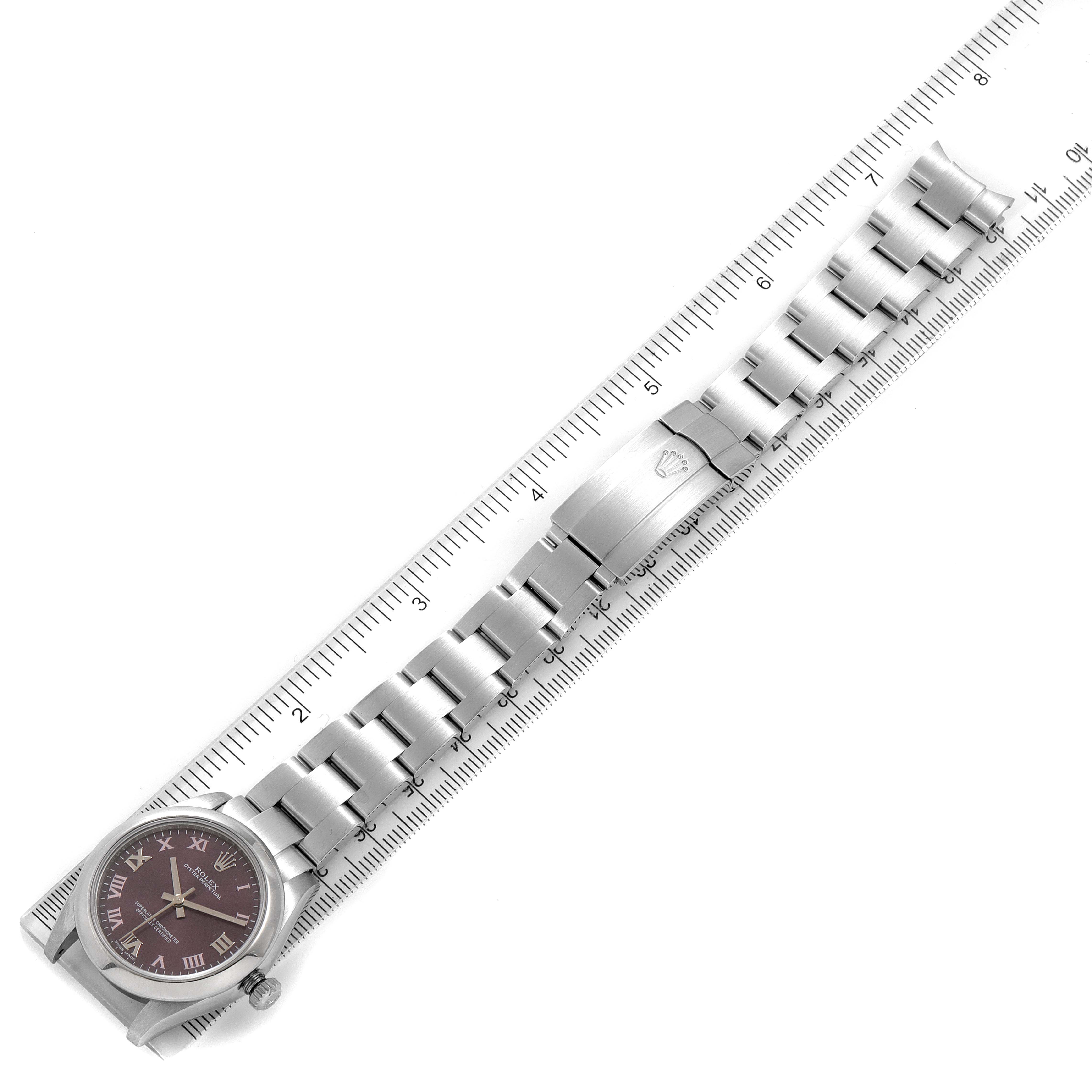 The image shows a fully extended Rolex Mid-Size 177200 Women's Stainless Steel Burgundy Dial 177200 Women's Stainless Steel Burgundy Dial model watch with its bracelet and clasp laid next to a ruler.