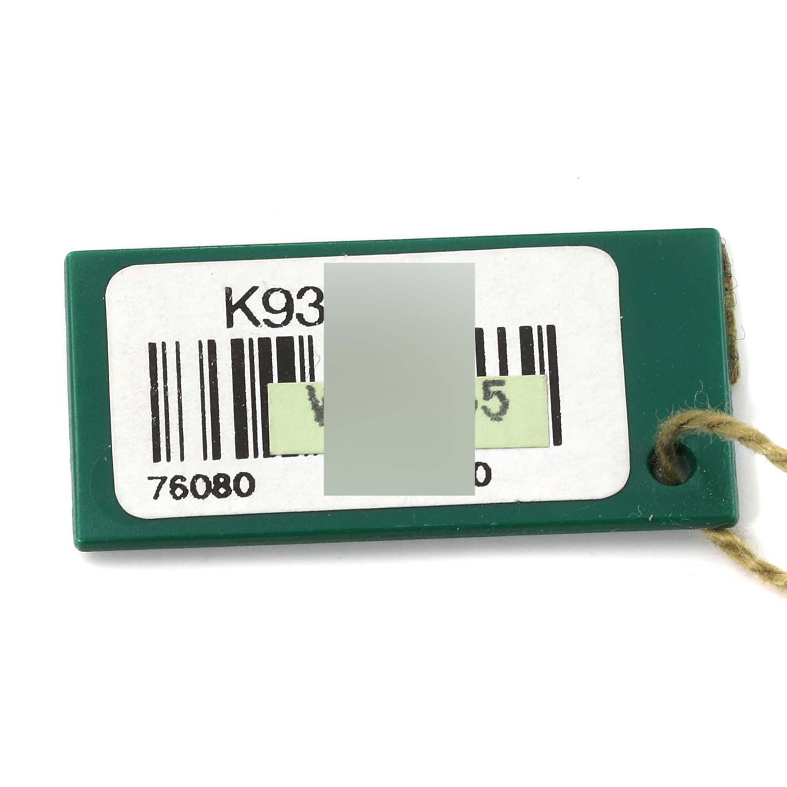 The image shows a label for an Oyster Perpetual model by Rolex, featuring barcodes and a hole for attachment.